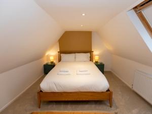 a bedroom with a large bed in the attic at A Hidden Gem in the Heart of Wells, Somerset in Wells