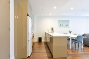cocina y sala de estar con mesa y sillas en Sydney CBD Modern 2 bedroom Apartment en Sídney