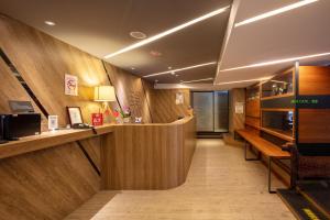 a hotel lobby with a reception counter and a desk at Chaiin Hotel - Dongmen in Taipei