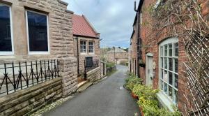 an alleyway between two brick buildings with a street at Chapel row 1 in Wirksworth