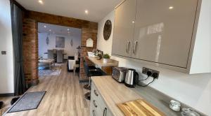 a kitchen with white cabinets and a counter top at Chapel row 1 in Wirksworth