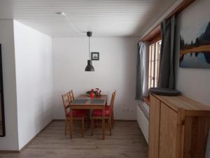 a dining room with a table and chairs and a window at Chalet Pfyffer - Mountain view in Grindelwald