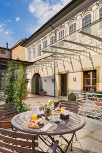 a table with food and drinks on a patio at Palacio de Aviles Affiliated By Melia in Avil&eacute;s