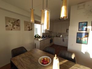 a kitchen with a table with a bowl of fruit on it at Helsinki Penthouse near the west harbor in Helsinki