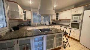 a kitchen with white cabinets and a granite counter top at Sunny Florida in Torrevieja