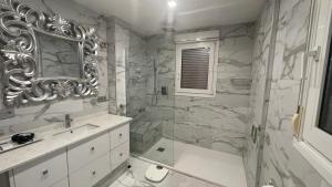 a bathroom with a tub and a sink and a mirror at Sunny Florida in Torrevieja +27 photos