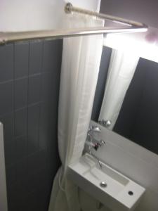 a bathroom with a sink and a mirror at Hotel Liselund in Nykøbing Falster