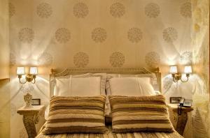 a bedroom with a bed with two pillows at Hotel Boutique Real Posada De Liena y Restaurante Liena in Murillo de Gállego