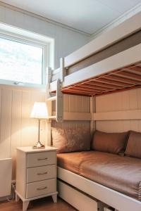 a bedroom with bunk beds with a lamp and a window at Loen Apartments in Loen