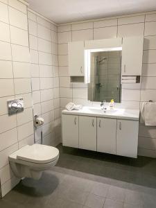 a bathroom with a toilet and a sink at Loen Apartments in Loen