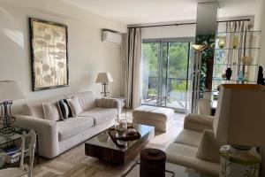 a living room with white furniture and a large window at Sea View & Large Terrace LIVE IN LA VISTA in Cannes