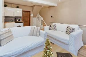 a living room with a white couch and a christmas tree at Whole house in Central Camden Town in London