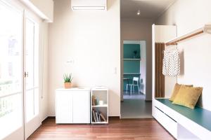 a living room with a white cabinet and a window at ViLLaRa: Style, Hospitality & Design (City Center) in Athens