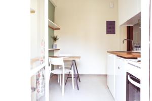 a small kitchen with a table and chairs in it at ViLLaRa: Style, Hospitality & Design (City Center) in Athens +8 photos