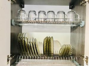 a row of glasses on a shelf in a kitchen at Apartaments in the city center in Karagandy