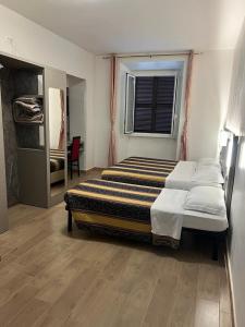 um quarto com 2 camas e uma janela em Hotel principe em Roma