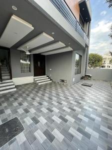 a large house with a checkered floor and a building at Bahria Residency in Rawalpindi