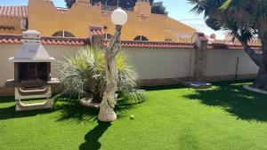 a yard with a light pole and a ball on the grass at Sunny Florida in Torrevieja