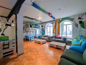 a living room with a couch and bunk beds at Whole Wide World Hostel in Zagreb