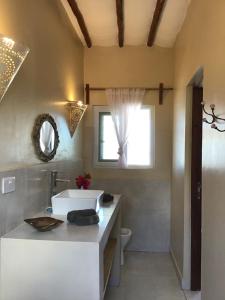 a bathroom with a white sink and a mirror at Nakupenda Malaika Flat in Pwani Mchangani +77 photos