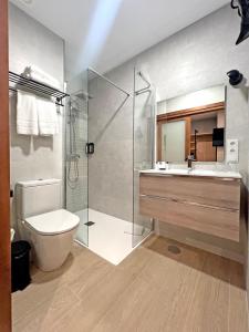 a bathroom with a shower and a toilet and a sink at Soho Boutique Columela in Cádiz +51 photos