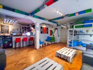 a room with a bunk bed and a bar at Whole Wide World Hostel in Zagreb