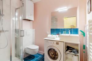 a bathroom with a washing machine and a sink at La Maison du pêcheur - Welkeys in Trouville-sur-Mer +4 photos