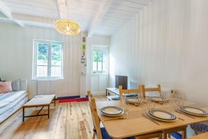 a living room with a table and a couch at La Maison du pêcheur - Welkeys in Trouville-sur-Mer