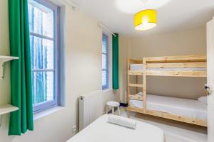 a room with two bunk beds and a window at Charming fisherman house in the center of Trouville - Welkeys in Trouville-sur-Mer