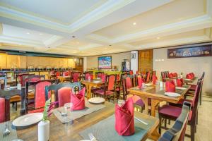 a restaurant with tables and chairs and red chairs at Summit Tashi Ghang Heritage Resort in Pelling