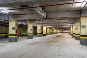 an empty parking lot in a parking garage at Tanau 1700 by SeaMount Rentals in Naut Aran