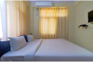 a large white bed in a room with a window at FabExpress Buddha Residency in Patna