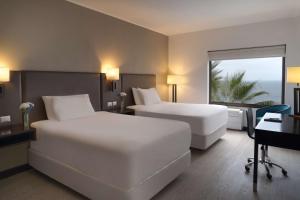 Letto o letti in una camera di NH Iquique Costa