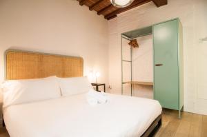 a bedroom with a white bed and a glass door at La Corte del Grillo in Perugia