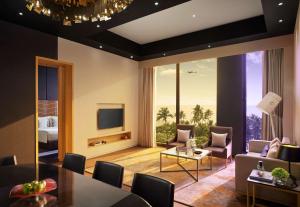 a living room with a couch and a table at Hyatt Centric Juhu Mumbai in Mumbai
