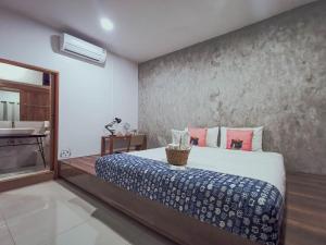 a bedroom with a large bed and a sink at Sleepy House Chiang Rai in Chiang Rai