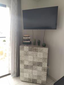 a flat screen tv on top of a dresser at Castle Harbour Home in Los Cristianos
