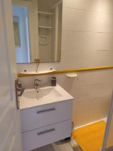 a bathroom with a white sink and a mirror at Castle Harbour Home in Los Cristianos