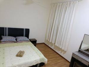 Postel nebo postele na pokoji v ubytování Aalif Homestay Sandakan