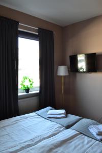 Postel nebo postele na pokoji v ubytování Hotell Skinnargården