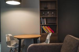 a living room with a table and a book shelf at Stylish flat in Rīga