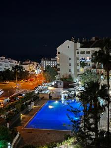 a view of a swimming pool at night at Castle Harbour Home in Los Cristianos