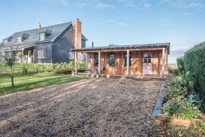 a house with a gravel driveway in front of it at Little Bramble, Orford in Orford