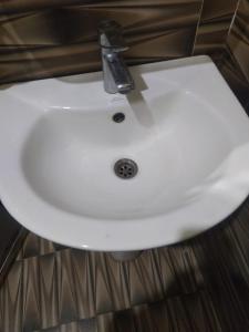 a bathroom sink with a faucet on top of it at Hotel Sauraha Gaida House in Chitwan