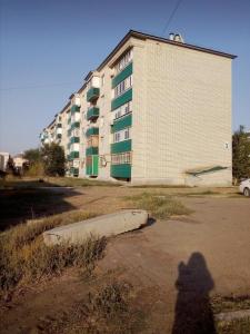 a shadow of a person standing in front of a building at Астана 3 in Oral