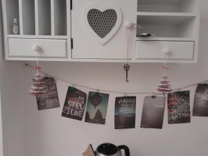 a bunch of books hanging on a kitchen wall at Albero della vita in Spotorno