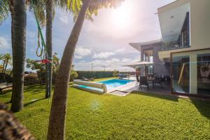 a swimming pool in the backyard of a house at Villa das Quebradas by An Island Apart in Funchal