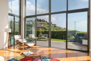 a living room with large windows and a view at Villa das Quebradas by An Island Apart in Funchal