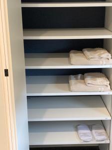 a closet with white shelves and folded towels at Kamiamakusa - House - Vacation STAY 54914v in Kami Amakusa