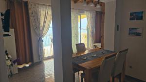 a dining room with a table and a balcony at Apartment in Tribunj with sea view, terrace, air conditioning, WiFi 68-2 in Tribunj